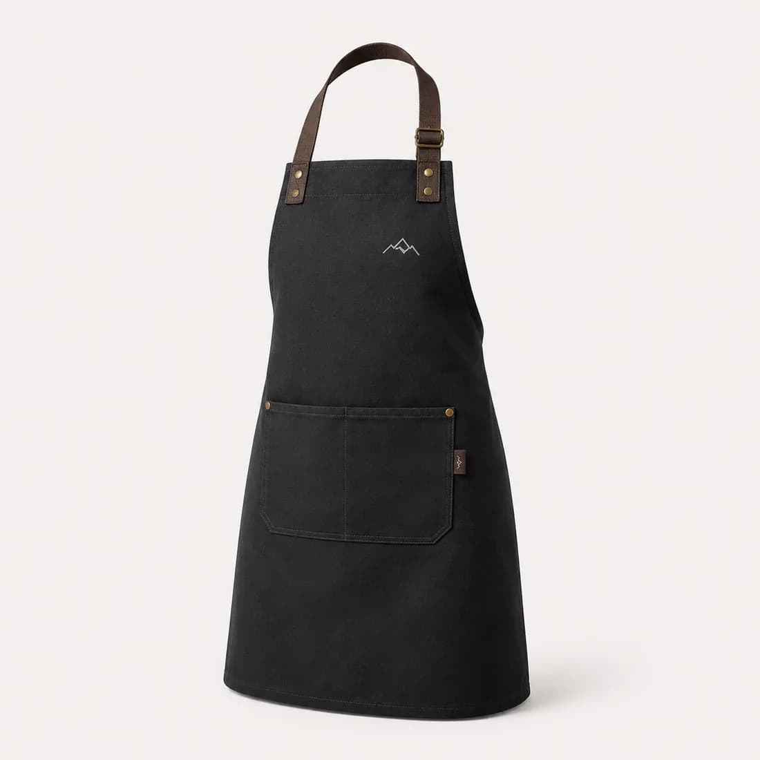 Black canvas bib apron with leather straps and an embroidered logo