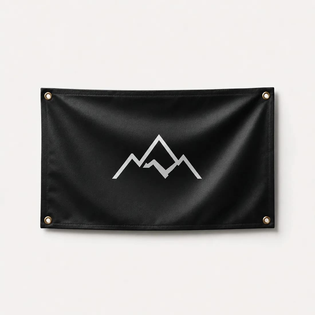 Black grommeted event banner with a printed mountain logo
